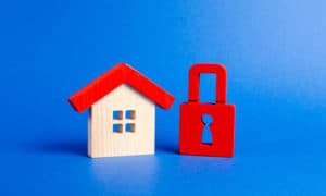 31422492 a wooden house and a red padlock unavailable and expensive real estate house insurance security and safety confiscation for debts alarm system seizure of property protection of property rights