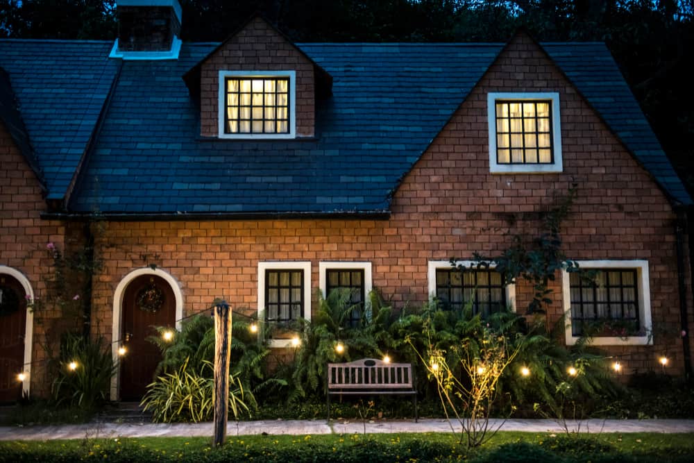 beautiful red brick house with decorative lights